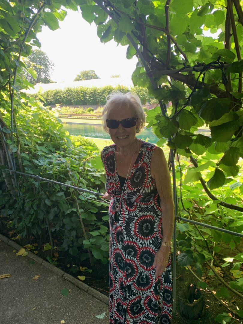 A woman standing in front of some trees