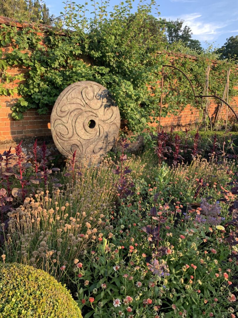 A garden with flowers and plants in the middle of it