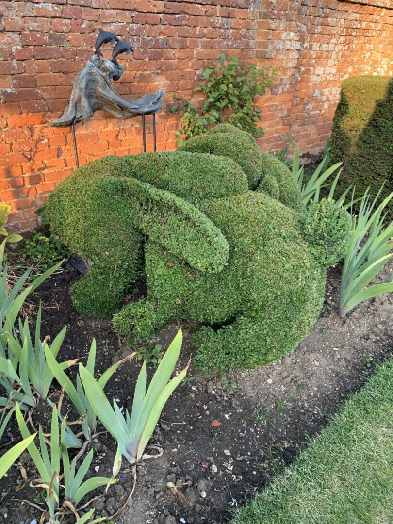 A garden with bushes shaped into animals.