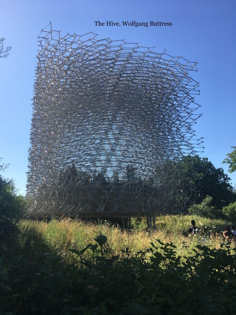 A large sculpture of bees flying in the sky.