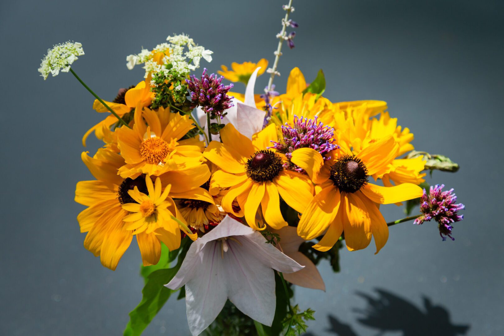 A bouquet of flowers that are yellow and purple.