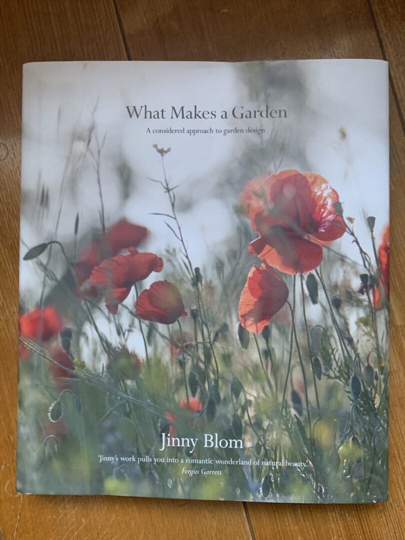 A book cover with red flowers in the background.