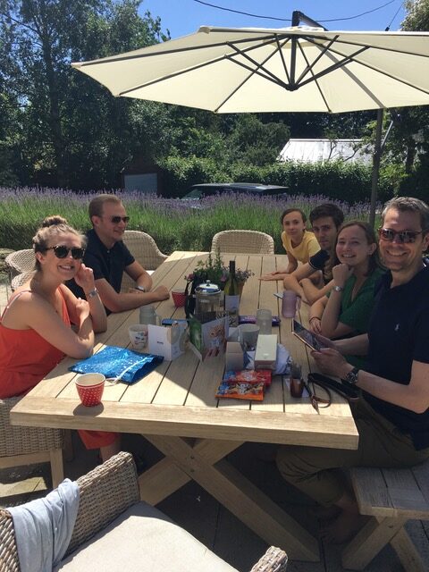 A group of people sitting at an outdoor table.