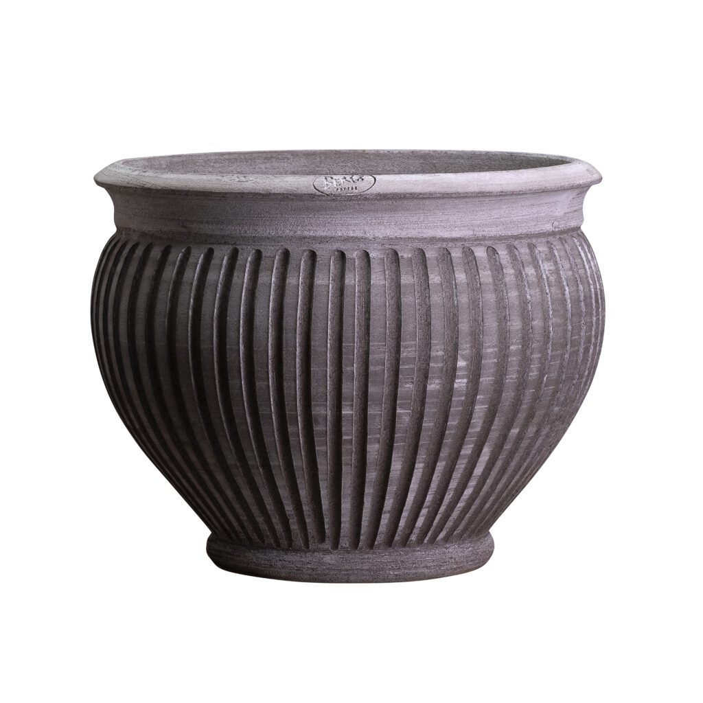 A large gray planter with a pattern of lines.