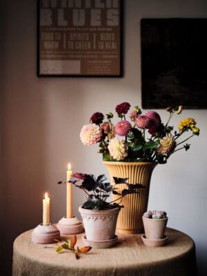 Flowers and candles on a round table.