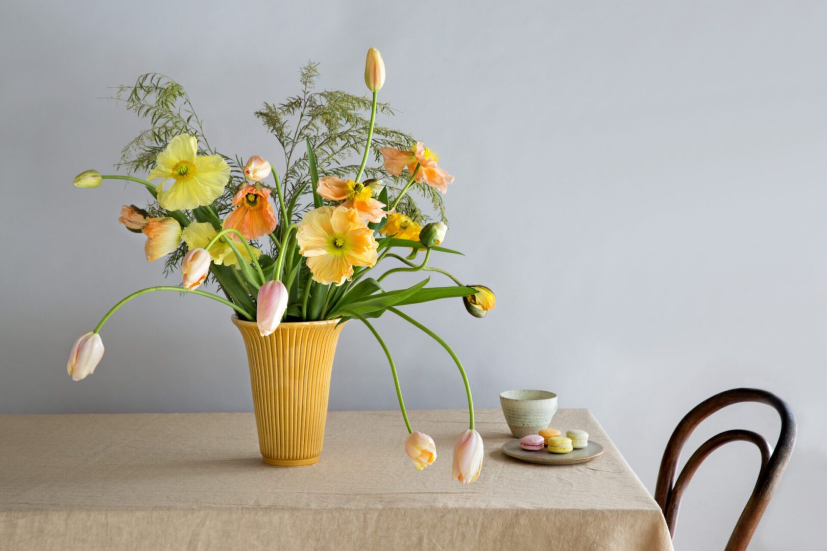 A table with a vase of flowers on it