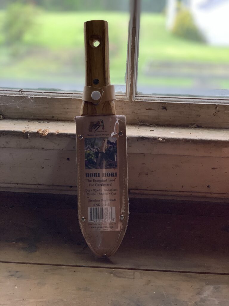 A wooden handle with a brown paper bag on it.