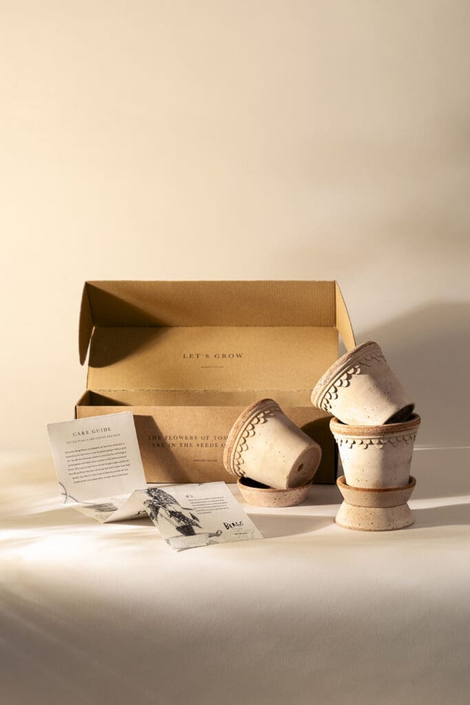 Ceramic pots with an open cardboard box.