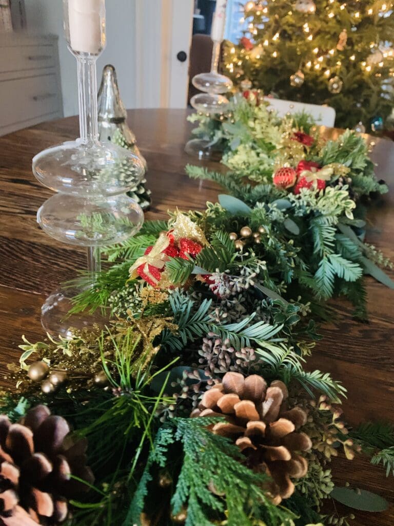 Festive table with Christmas garland centerpiece.